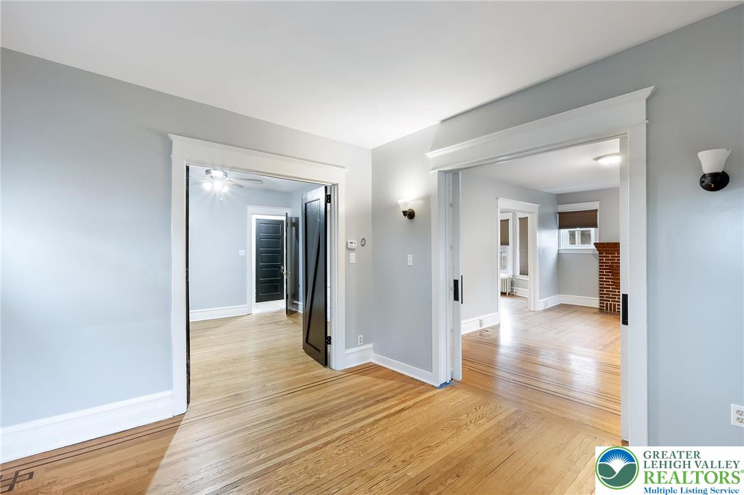 1150 North 19th Street, Unit 1 Allentown, PA 18104 - Photo 17 of 32 a view of a hallway with wooden floor and a living room