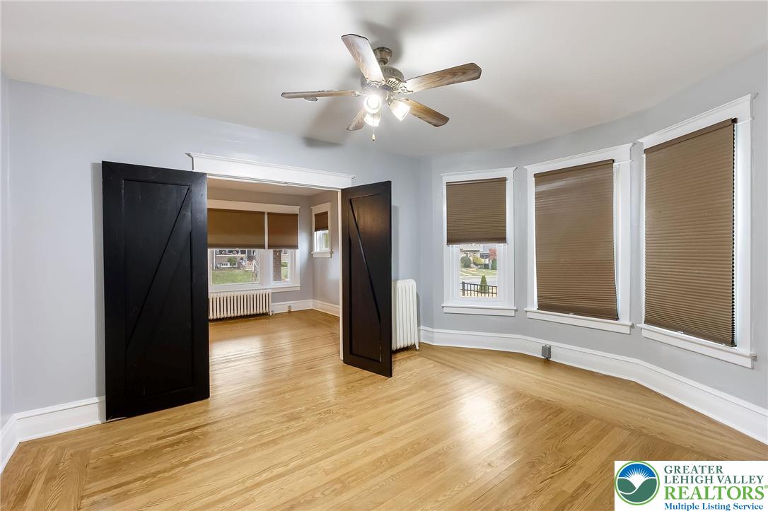 1150 North 19th Street, Unit 1 Allentown, PA 18104 - Photo 18 of 32 a view of an empty room with window and wooden floor