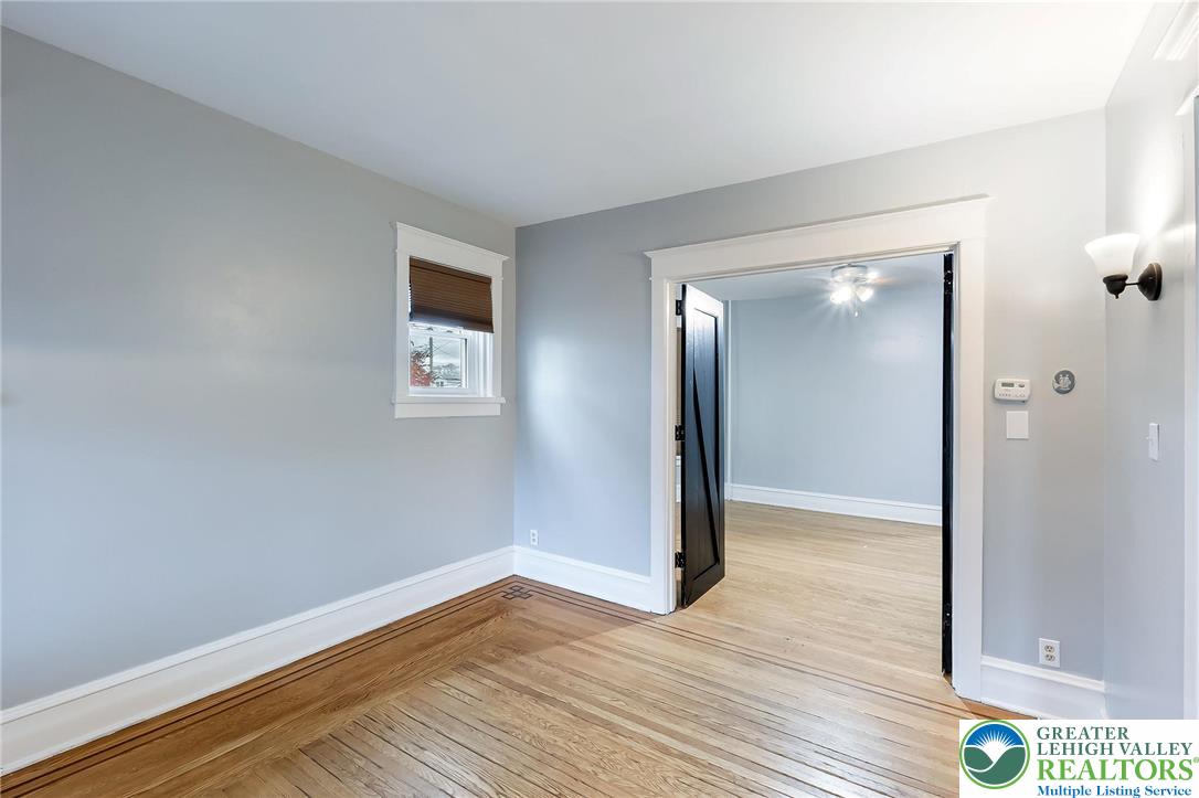 1150 North 19th Street, Unit 1 Allentown, PA 18104 - Photo 20 of 32 a view of an empty room with wooden floor and a window