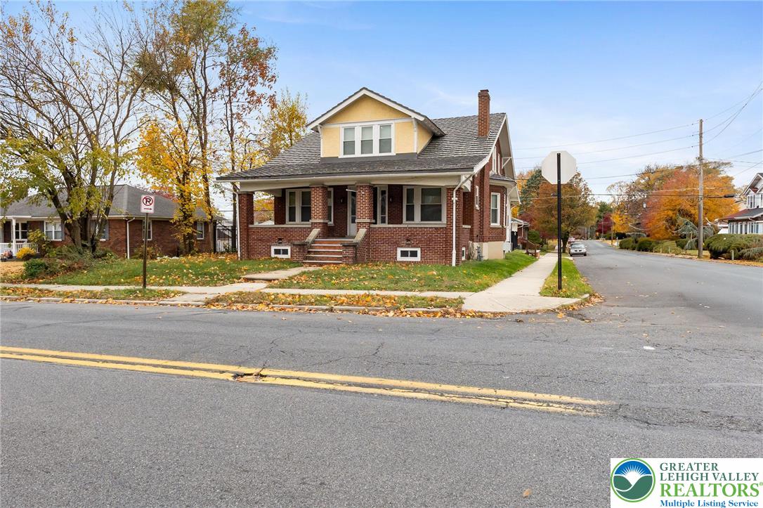 1150 North 19th Street, Unit 1 Allentown, PA 18104 - Photo 2 of 32 a front view of residential houses with yard and trees