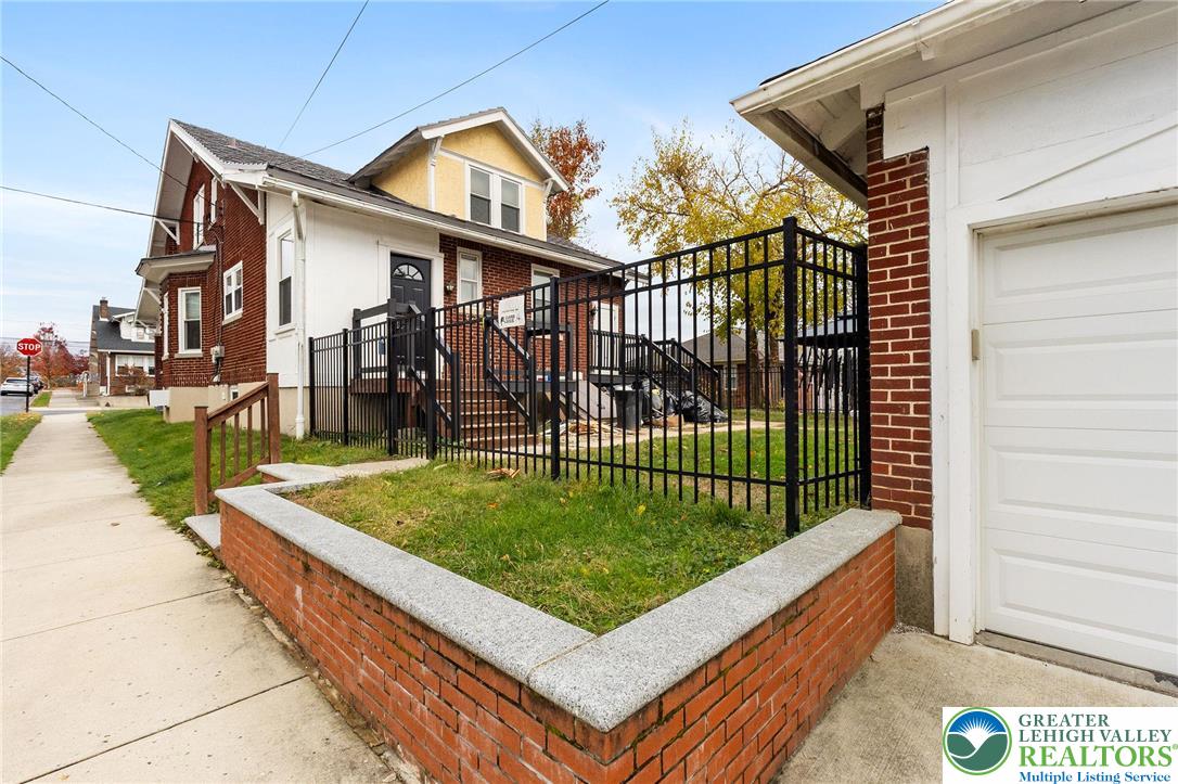 1150 North 19th Street, Unit 1 Allentown, PA 18104 - Photo 28 of 32 a view of a white house with a small yard and plants