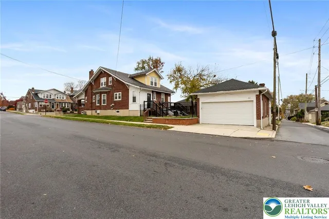 a car parked in front of house with yard
