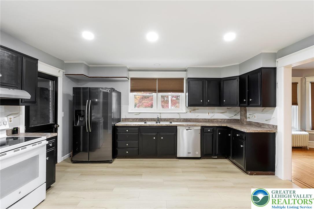 1150 North 19th Street, Unit 1 Allentown, PA 18104 - Photo 5 of 32 a large kitchen with kitchen island granite countertop a sink and refrigerator