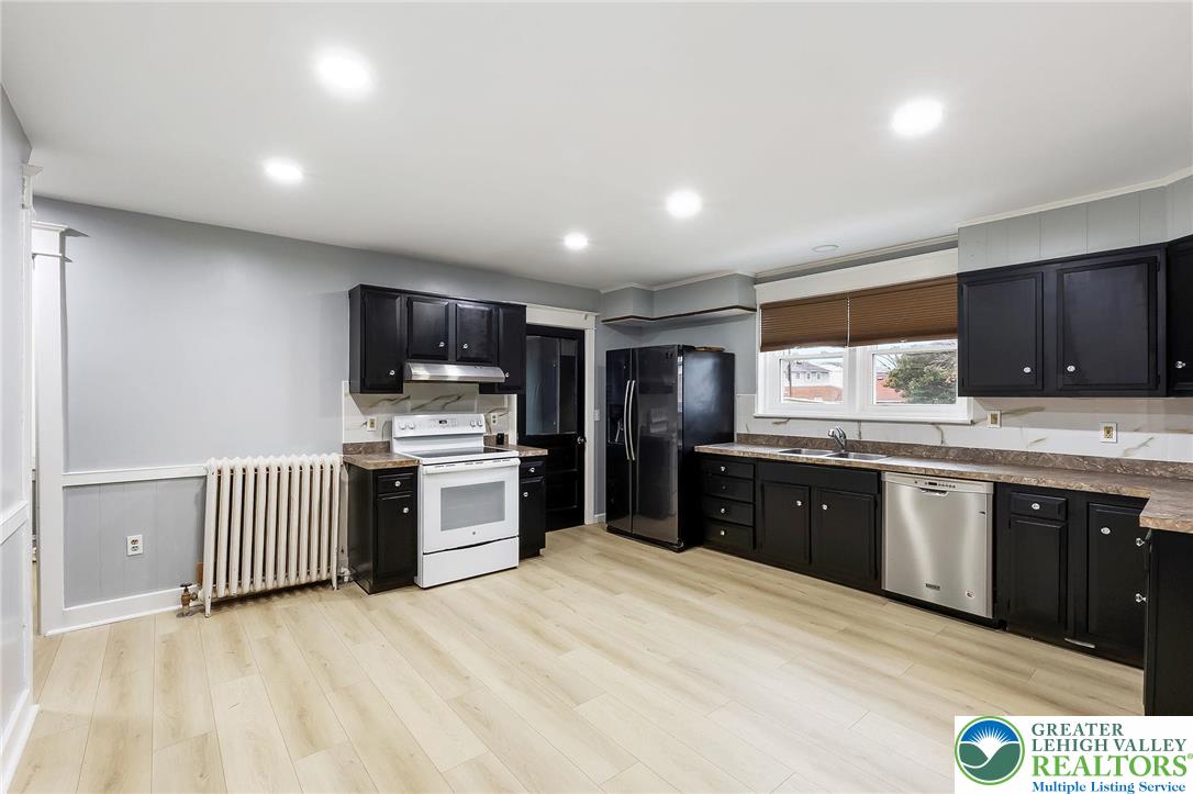 1150 North 19th Street, Unit 1 Allentown, PA 18104 - Photo 6 of 32 a kitchen with stainless steel appliances granite countertop a stove a sink dishwasher and a refrigerator