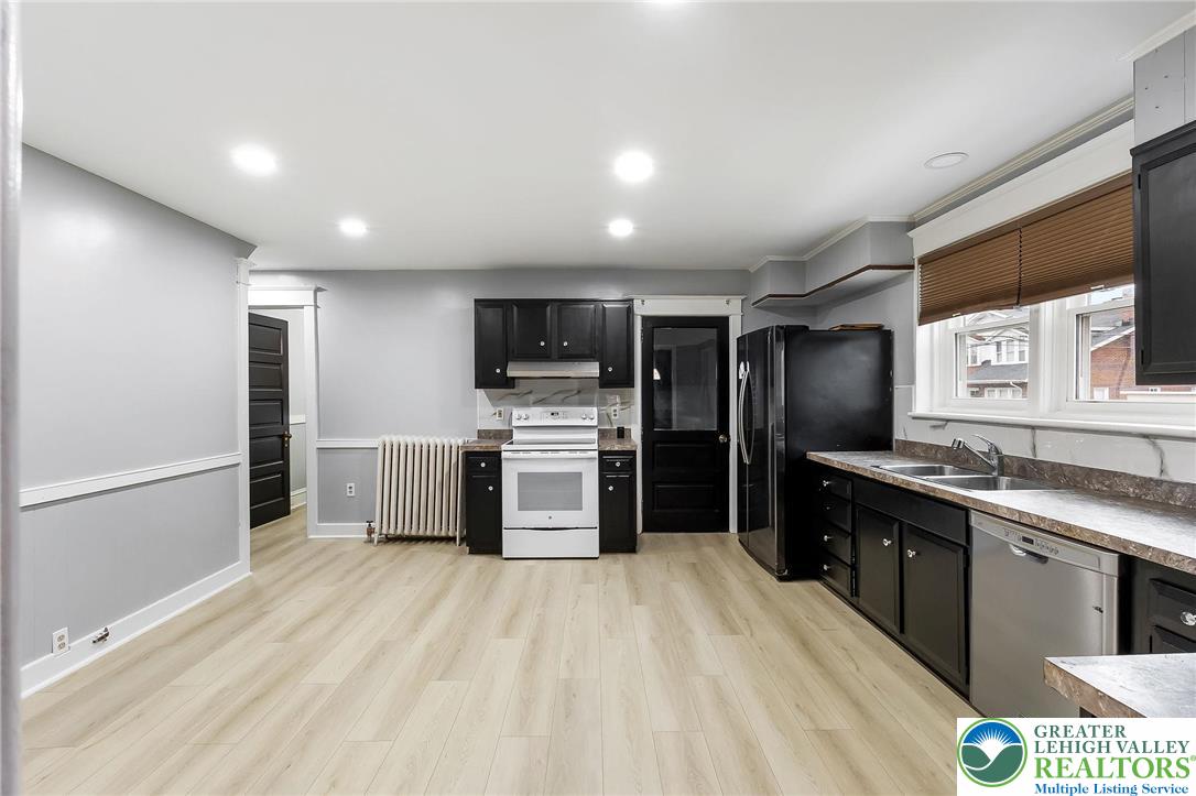 1150 North 19th Street, Unit 1 Allentown, PA 18104 - Photo 7 of 32 a kitchen with stainless steel appliances a refrigerator a sink a stove top oven a sink and dishwasher