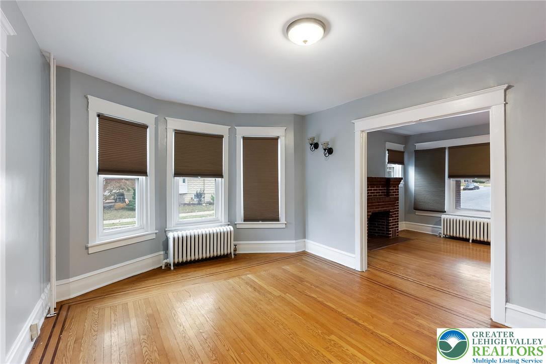 1150 North 19th Street, Unit 1 Allentown, PA 18104 - Photo 9 of 32 an empty room with wooden floor and windows