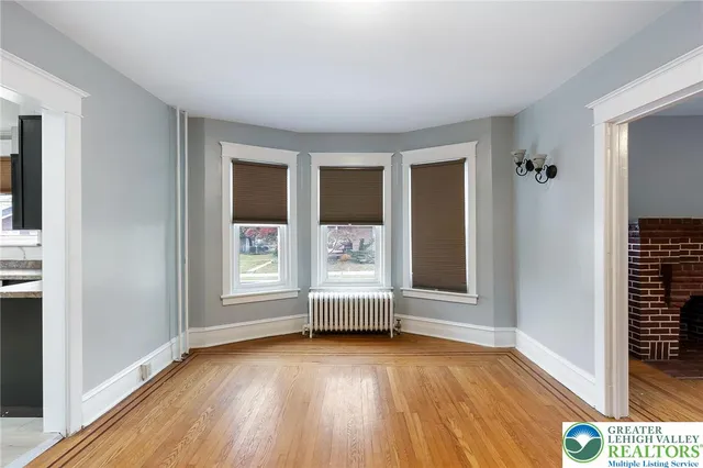 an empty room with windows and closet