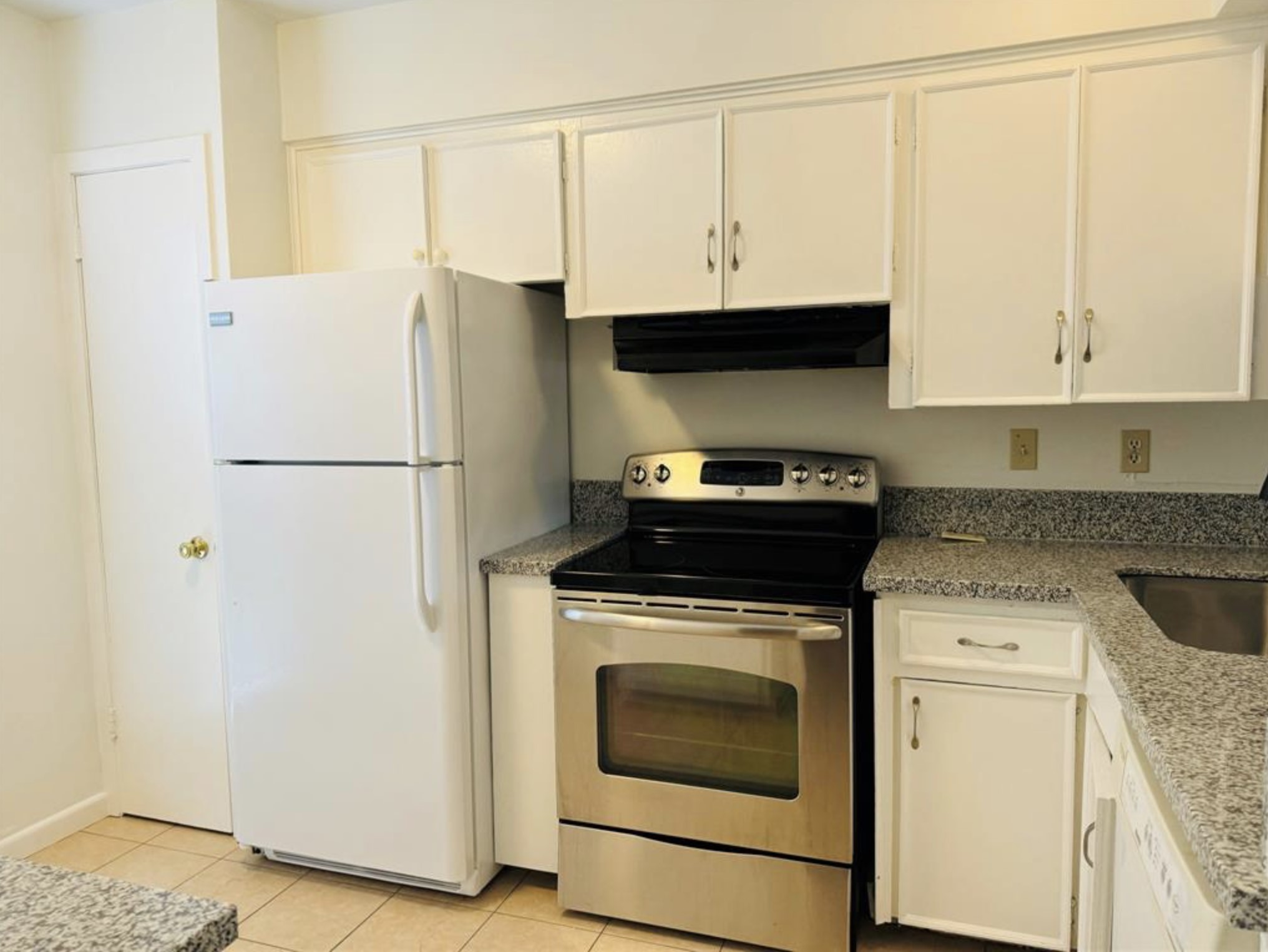 7841 Rue St Cyr Street, Unit 45 Houston, TX 77074 - Photo 4 of 7 a kitchen with stainless steel appliances granite countertop a refrigerator a stove a sink and white cabinets