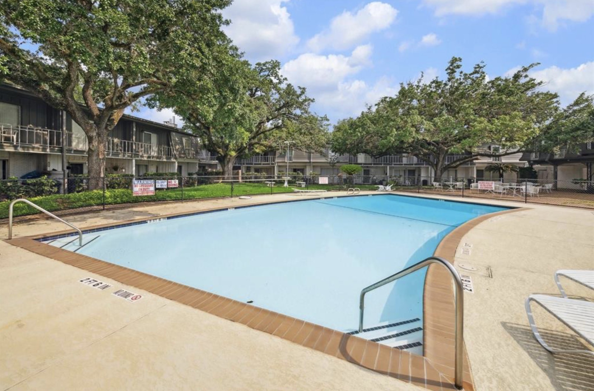 7841 Rue St Cyr Street, Unit 45 Houston, TX 77074 - Photo 6 of 7 a view of swimming pool with seating area and trees around
