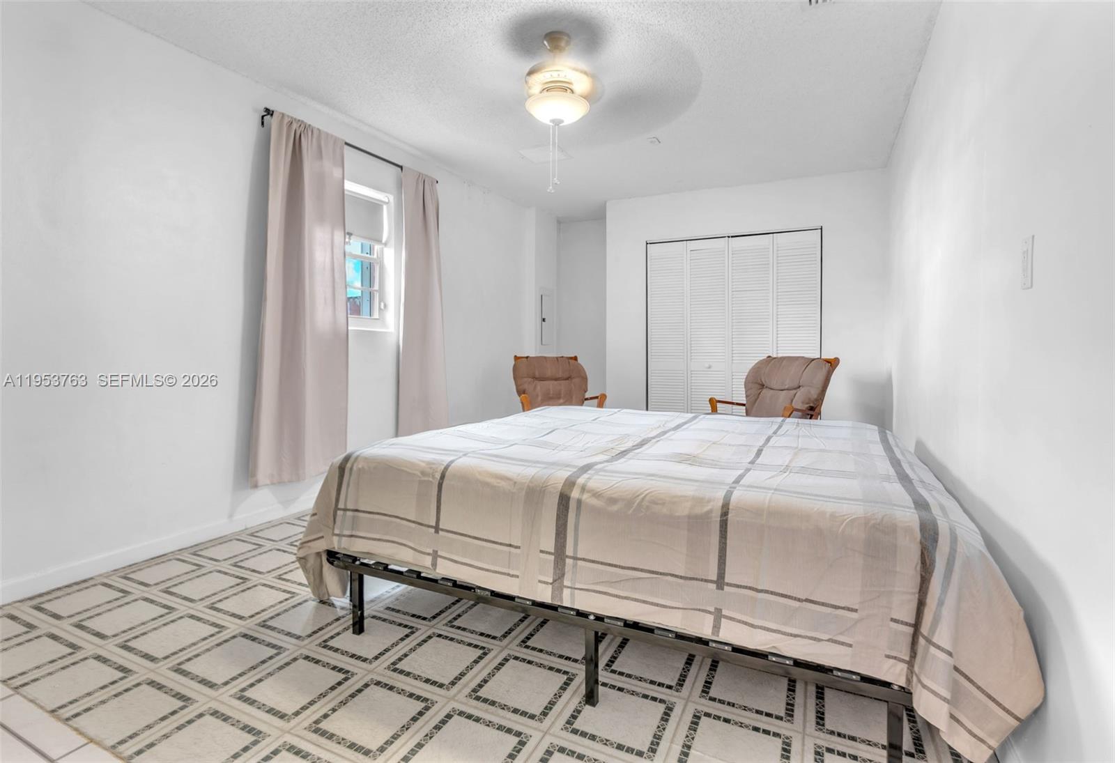 1002 Southwest 142nd Court Miami, FL 33184 - Photo 14 of 50 a bedroom with a bed and a window