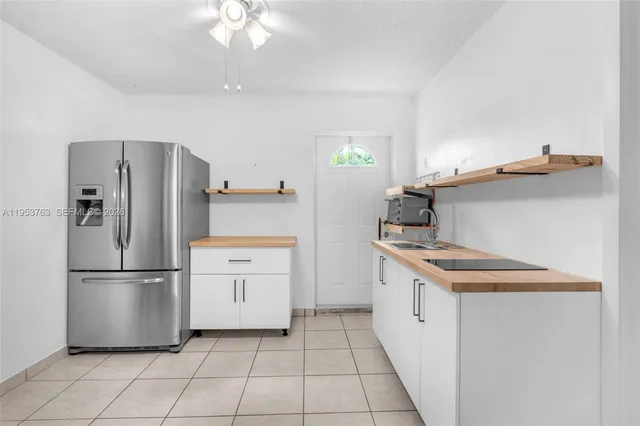 a kitchen with a refrigerator and a sink