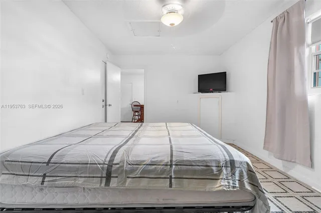 a bedroom with a bed and a flat screen tv