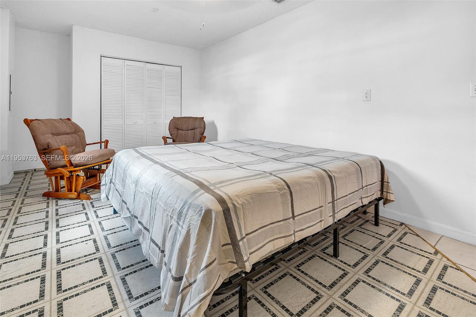 1002 Southwest 142nd Court Miami, FL 33184 - Photo 17 of 50 a bedroom with a bed and chair