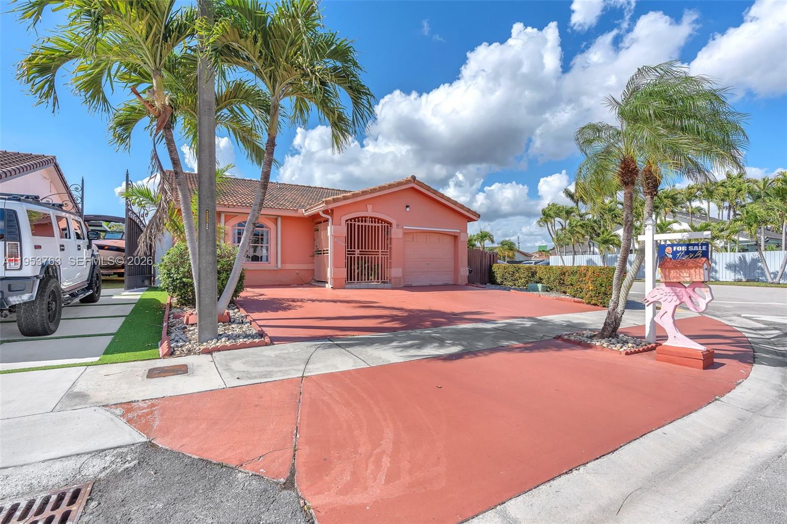 1002 Southwest 142nd Court Miami, FL 33184 - Photo 2 of 50 a front view of a house with garden and patio