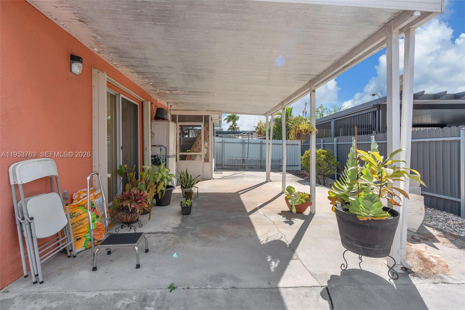 1002 Southwest 142nd Court Miami, FL 33184 - Photo 25 of 50 a building outdoor space with patio furniture and potted plants