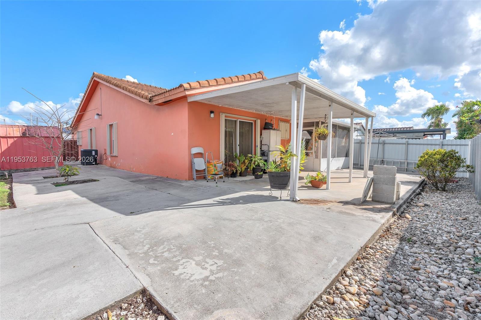 1002 Southwest 142nd Court Miami, FL 33184 - Photo 26 of 50 a view of a house with backyard and sitting area