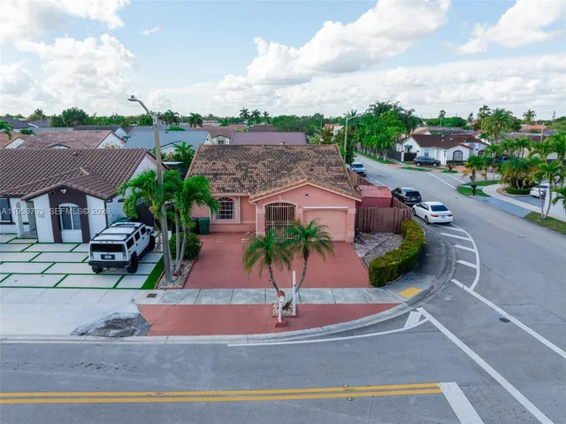 an aerial view of a house with a garden space and street view