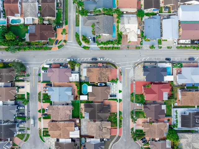 an aerial view of houses with an outdoor space