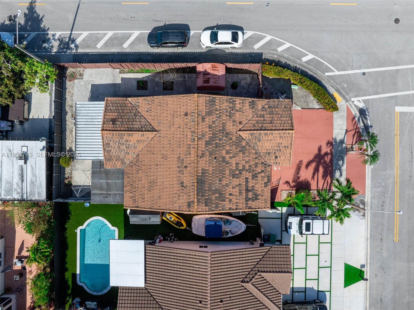 1002 Southwest 142nd Court Miami, FL 33184 - Photo 43 of 50 a backyard of a house with seating space and trees