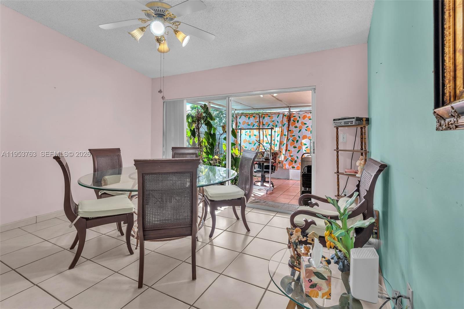 1002 Southwest 142nd Court Miami, FL 33184 - Photo 6 of 50 a view of a dining room with furniture a livingroom and chandelier