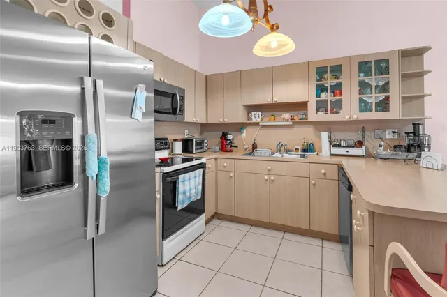 a kitchen with a sink cabinets and stainless steel appliances