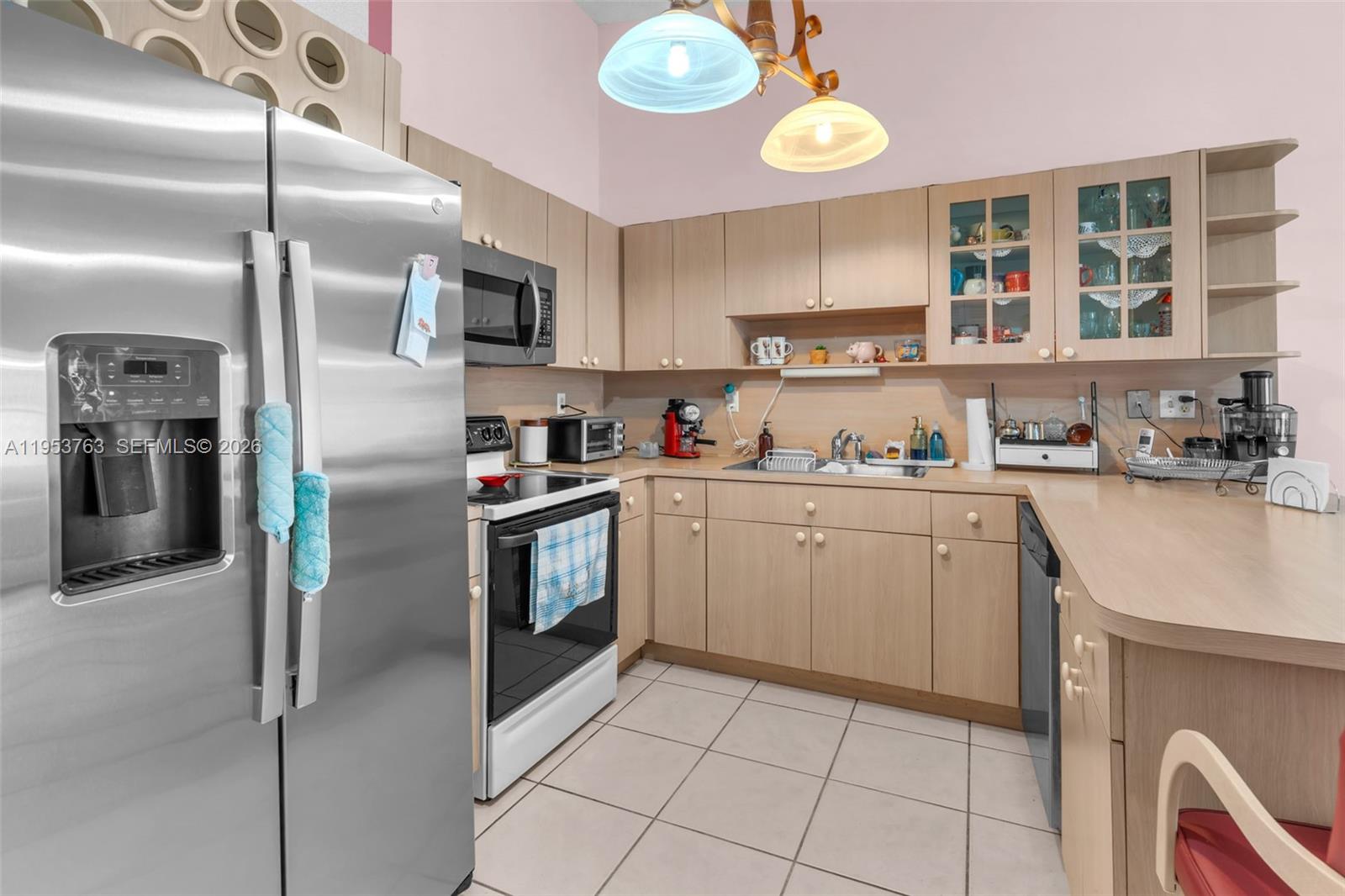 1002 Southwest 142nd Court Miami, FL 33184 - Photo 9 of 50 a kitchen with a sink cabinets and stainless steel appliances