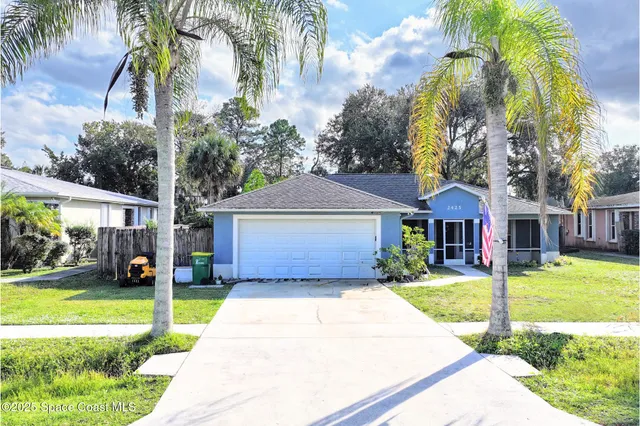 a front view of a house with a yard garage and outdoor seating