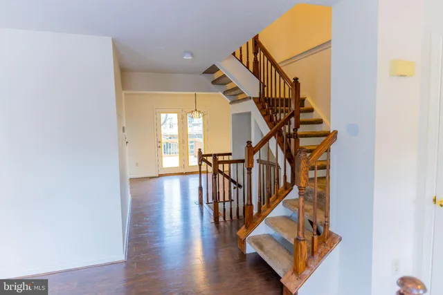 a view of entryway with wooden floor and stairs
