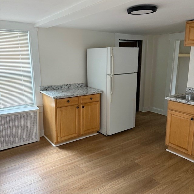 254 Rice Avenue, Unit 1 Northborough, MA 01532 - Photo 3 of 9 a view of a kitchen with a refrigerator a stove top oven and a refrigerator