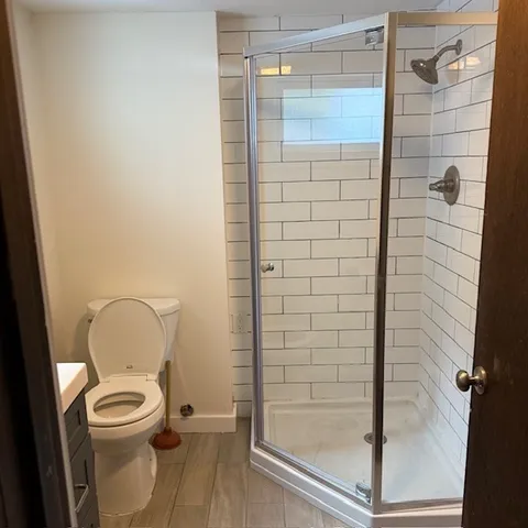 a bathroom with a toilet and a shower