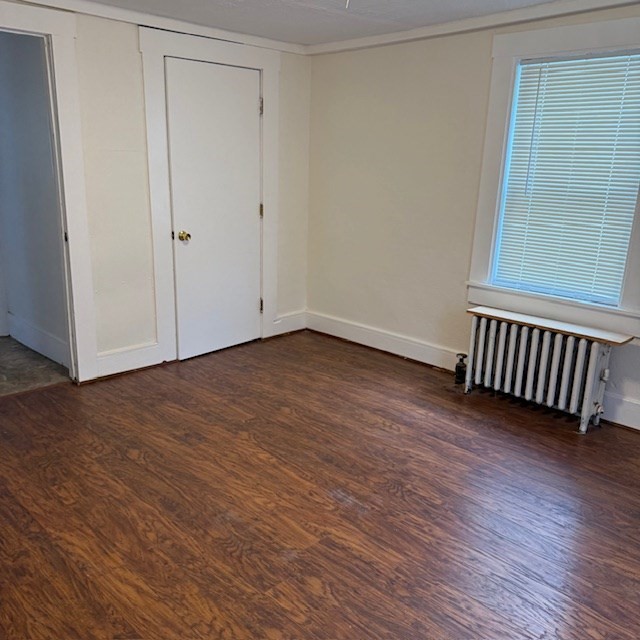 254 Rice Avenue, Unit 1 Northborough, MA 01532 - Photo 6 of 9 a view of an empty room with wooden floor and a window