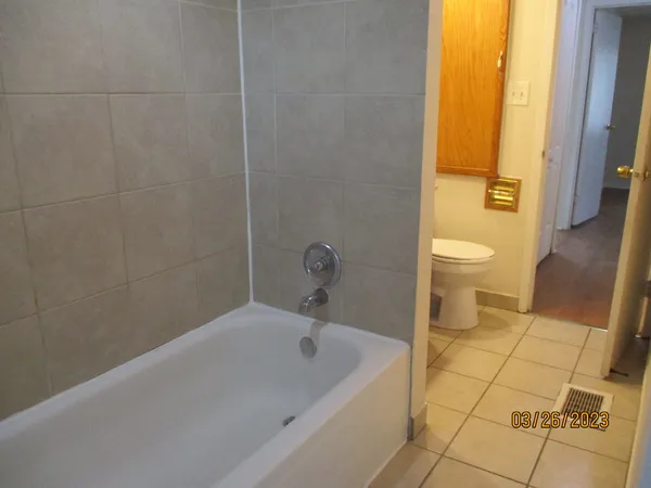 a bathroom with a bathtub and toilet