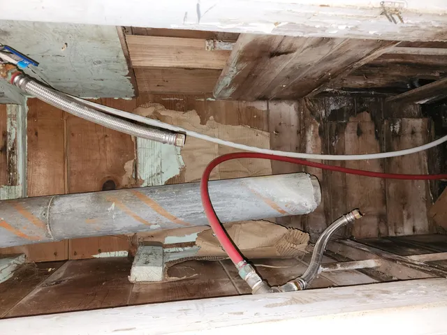 a kitchen with cabinets appliances and a sink