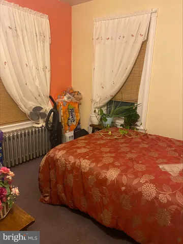 a bed sitting in a bedroom and dresser