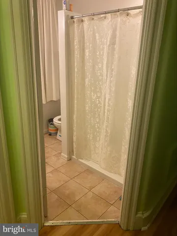 a bedroom with a bed and a mirror