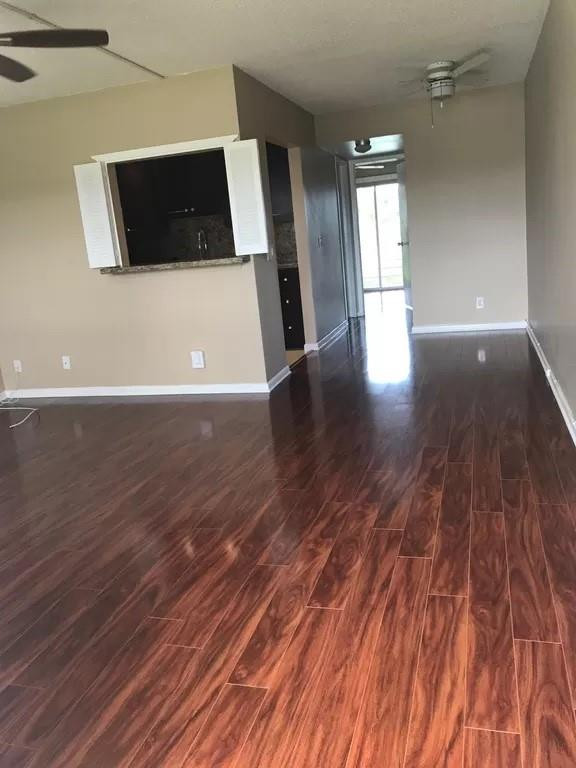 21 Dorset A Boca Raton, FL 33434 - Photo 3 of 7 a view of a living room hardwood floor and a ceiling fan