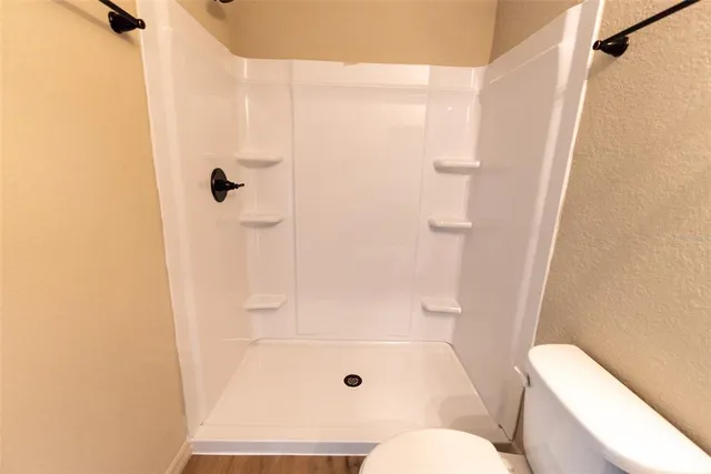 a bathroom with a shower and a toilet
