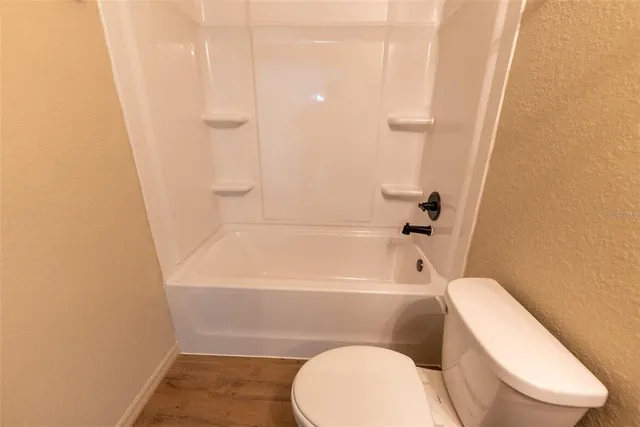 a bathroom with a toilet and bathtub