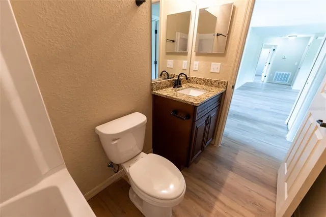 a bathroom with a toilet a sink and a mirror