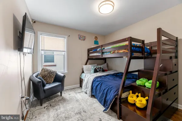 a bedroom with bed and a couch