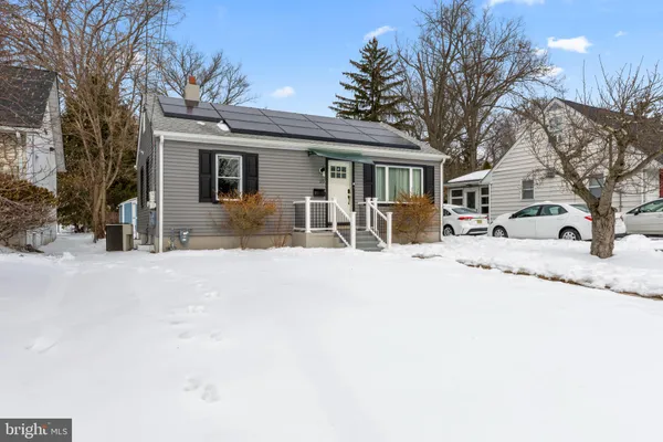 a view of a house with snow on the road