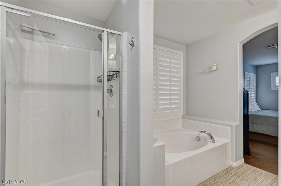 48 Jasmine Point Street Henderson, NV 89074 - Photo 42 of 62 Indulge in a tranquil primary bathroom featuring a spacious walk-in shower and a built-in soaking tub.
