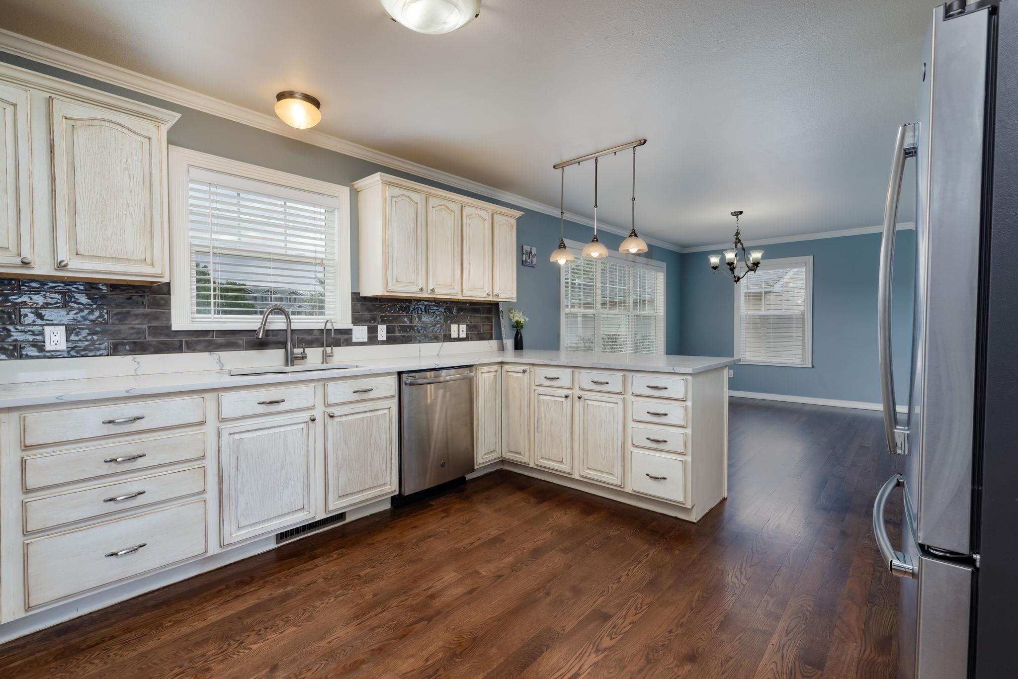 1168 Windsor Park Drive Fruita, CO 81521 - Photo 12 of 41 a kitchen with white cabinets and white appliances