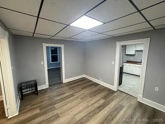 an empty room with wooden floor and cabinet
