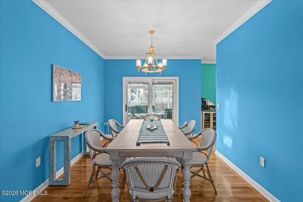 a view of a dining room with furniture wooden floor and a chandelier
