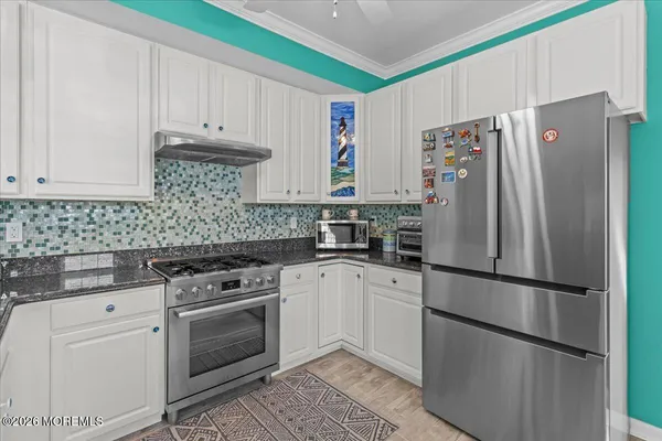 a kitchen with stainless steel appliances a refrigerator sink and cabinets
