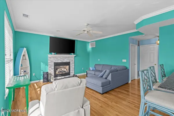 a living room with furniture a flat screen tv and a fireplace