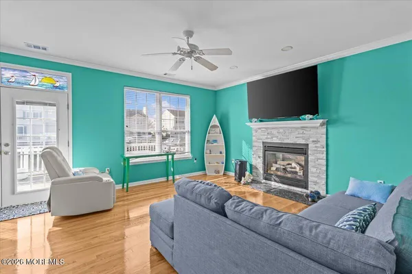 a living room with furniture a flat screen tv and a fireplace