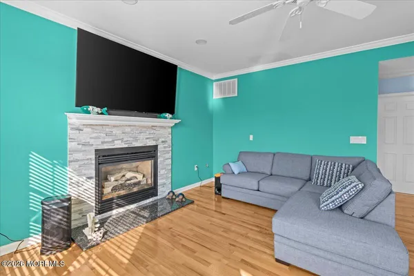 a living room with furniture a flat screen tv and a fireplace