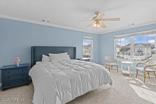 a bedroom with a bed a chandelier and a window